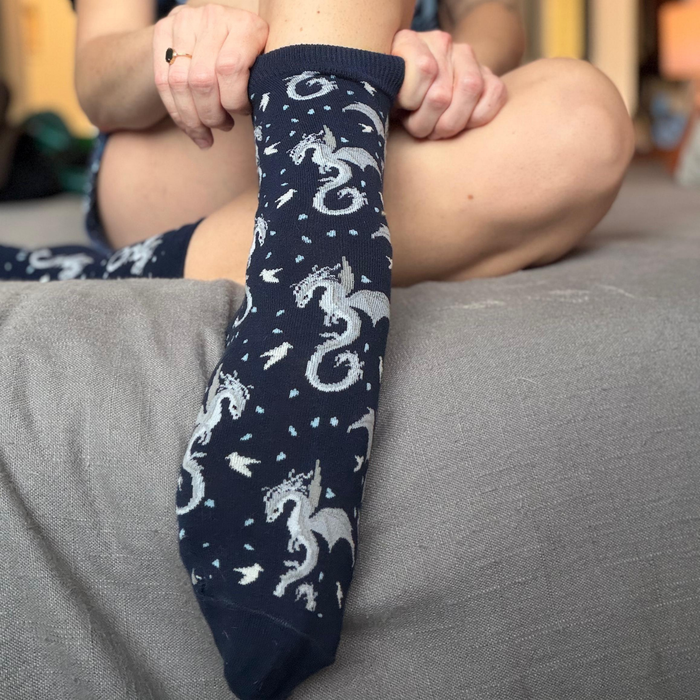 Socks featuring a Moonplume Dragon from the book When The Moon Hatched by Sarah A. Parker